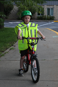 Child on bike with reflective vest