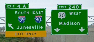Examples of left-hand and center lane exit signs.