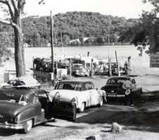 Black and white photo of cars waiting in line to board the Merrimac Ferry, Colsac I.