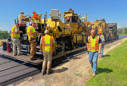 Crews work on asphalt paving operations on rural Wisconsin highway