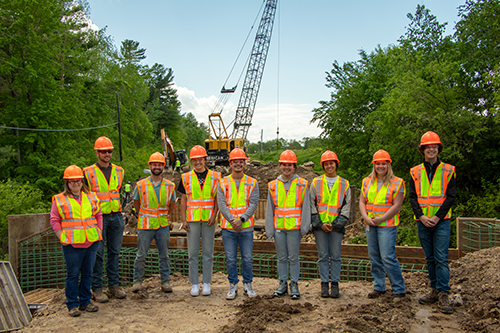 Group photo of WisDOT interns at a construction site.