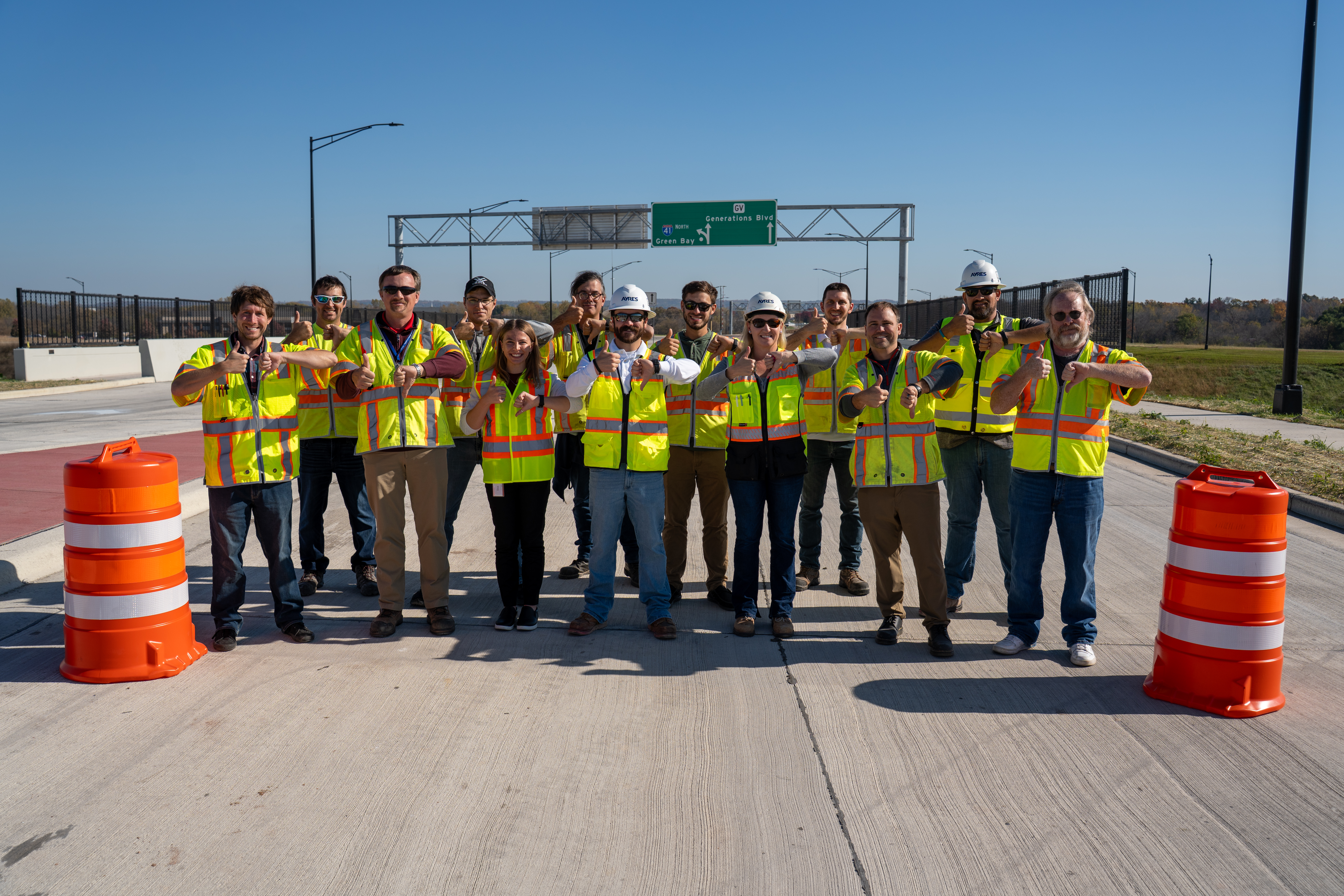 Wisconsin Department of Transportaton staff posing with one thumb up and one thumb down