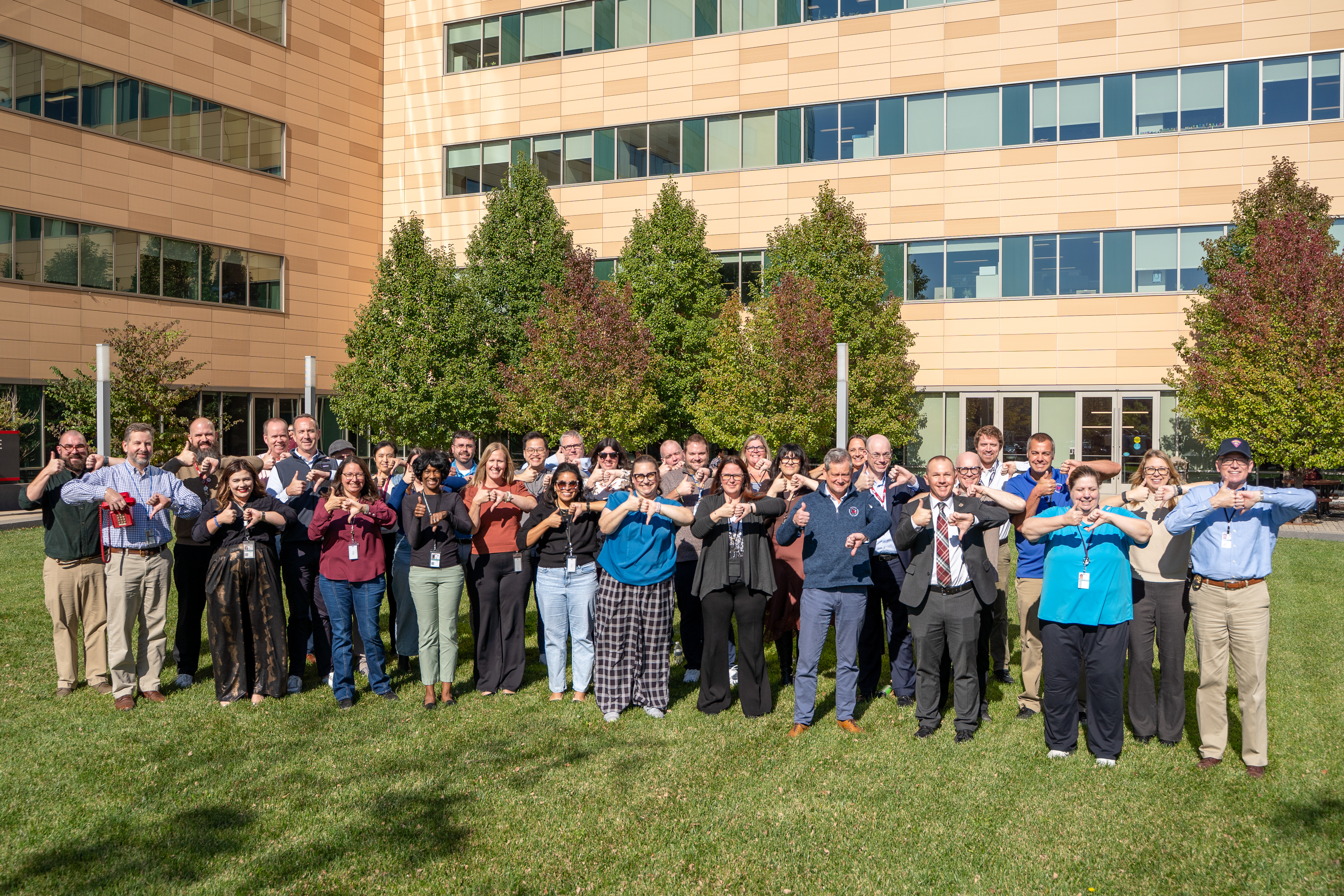 Wisconsin Department of Transportaton staff posing with one thumb up and one thumb down
