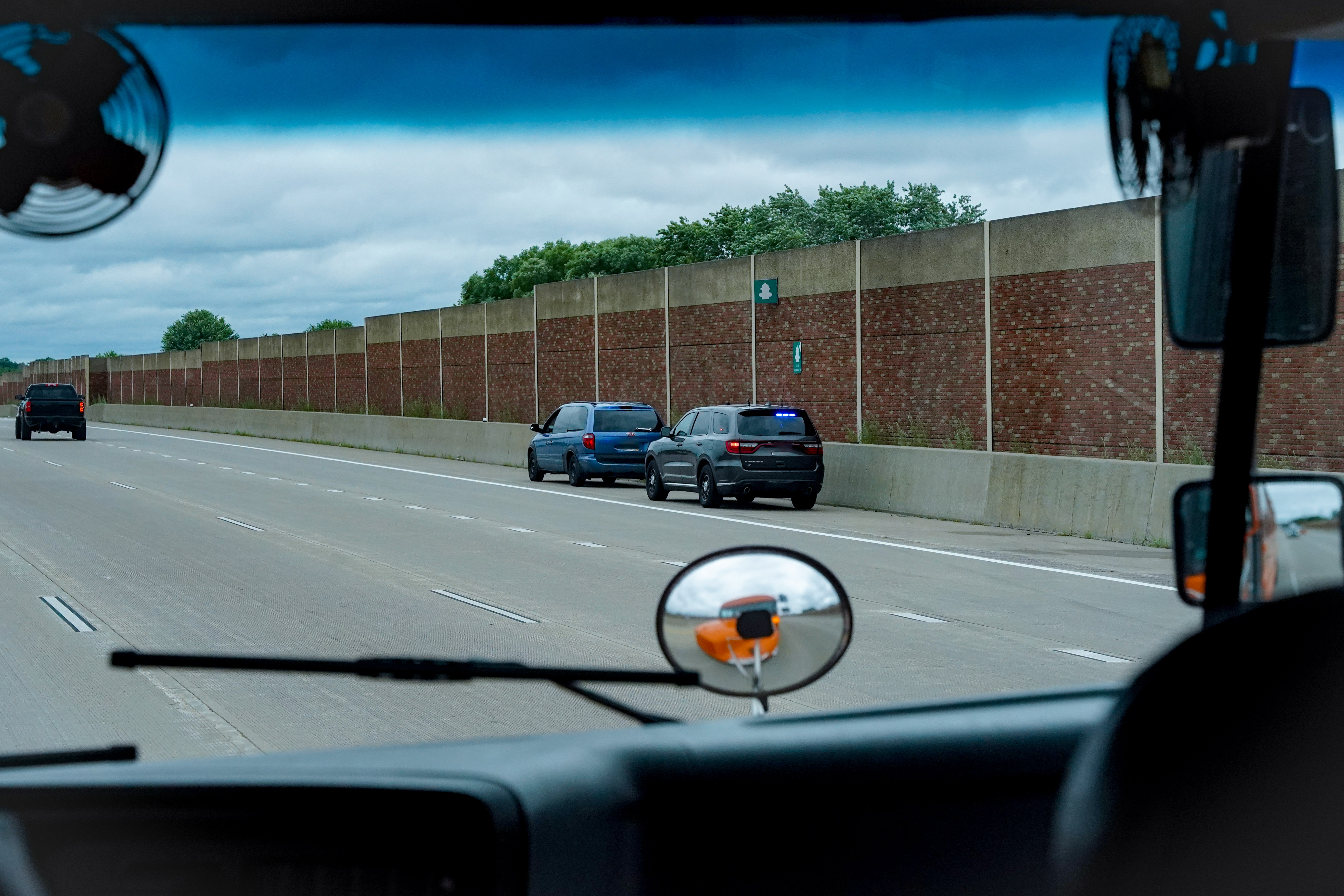 Vehicle pulled over by an officer, view from the passenger seat while passing the stopped vehicles