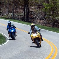 Two motorcycles taking a corner