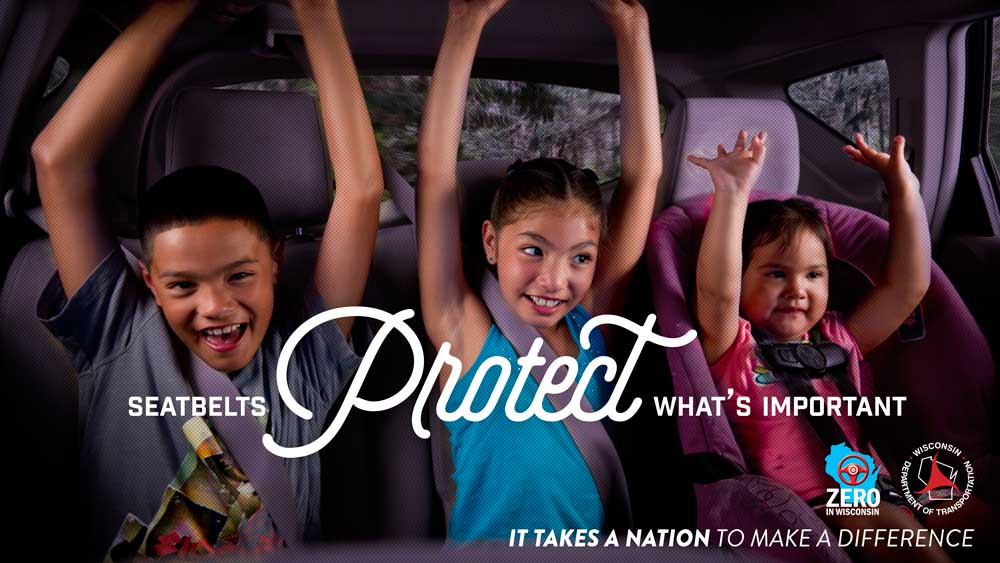 Seatbelts protect what's important. Three children are riding in the backseat of a car.