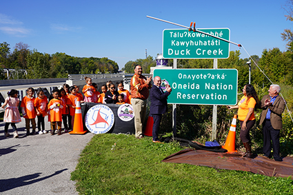 Representatives from WisDOT and Oneida nation at the unveiling of the Oneida dual language signs.