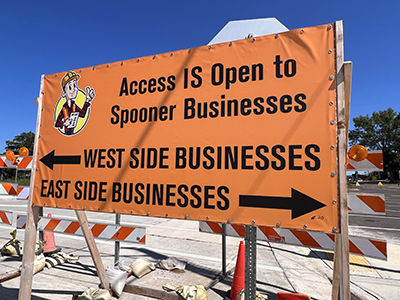 Large orange sign: Access is Open to Spooner Businesses.