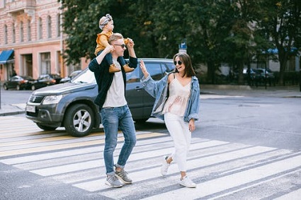 family crossing the street