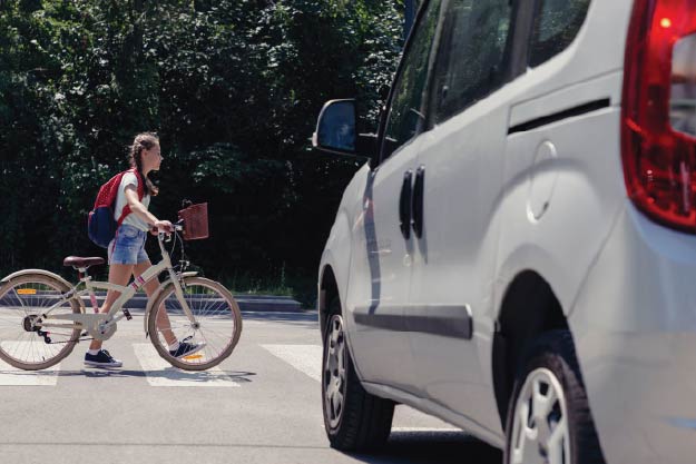 Image of pedestrian in crosswalk with yielding vehicle