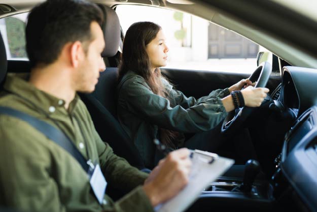 Image of driver taking behind the wheel driver exam
