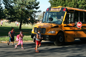 Children crossing in front of a school bus