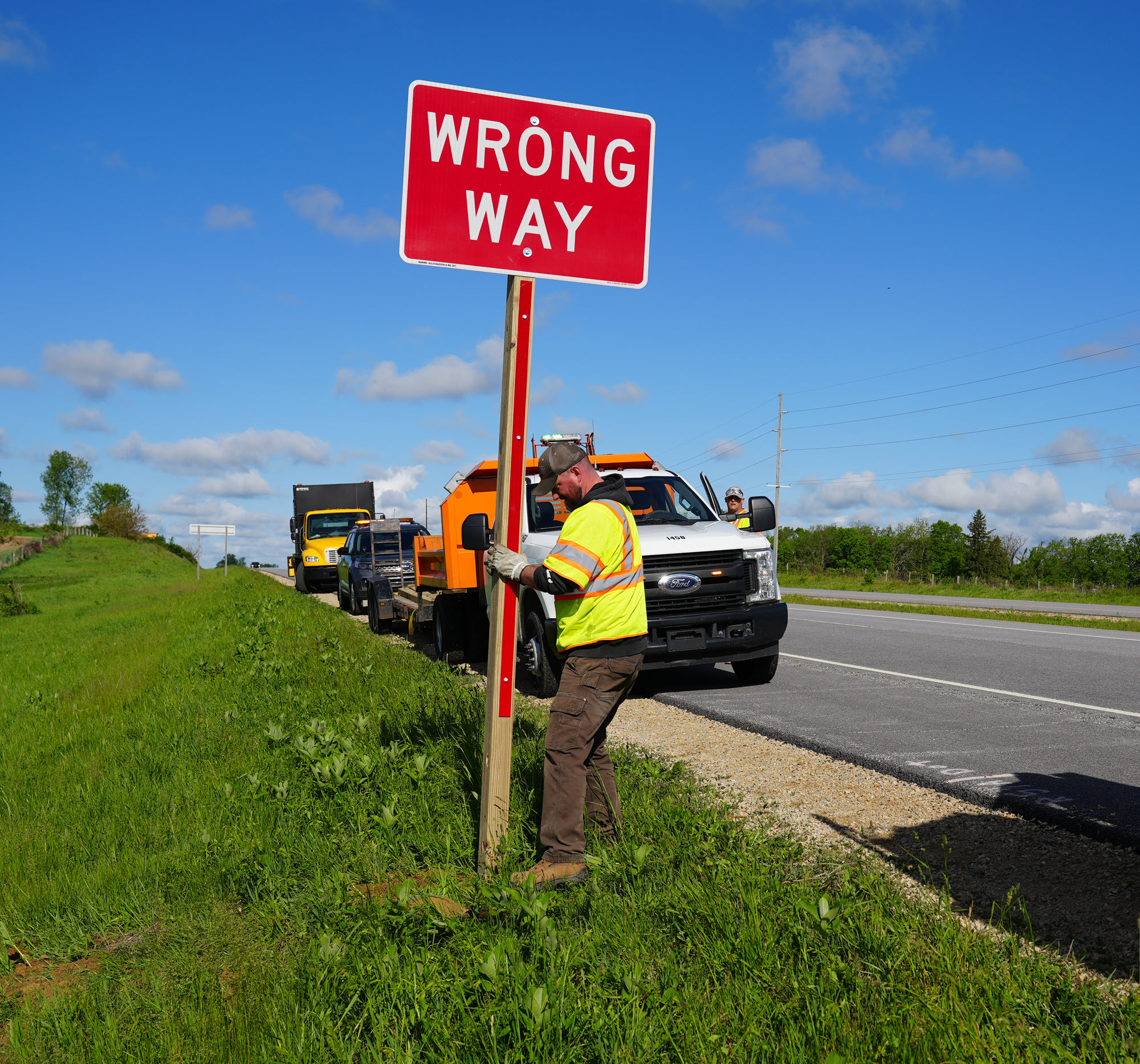 A man install wrong way sign