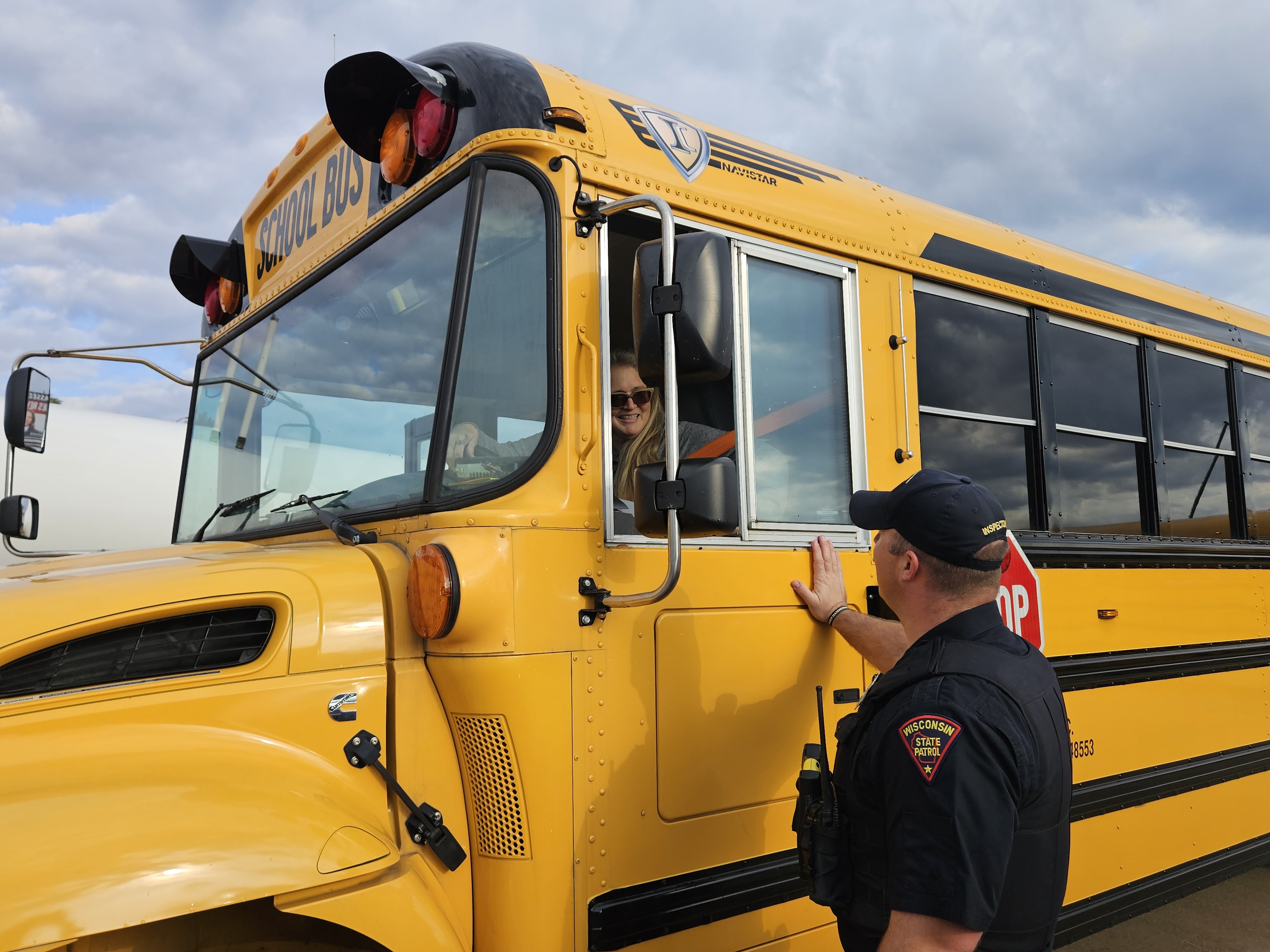 Wisconsin State Patrol officer talking with bus driver